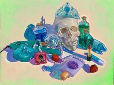 there is a skull surrounded by items on the table, including perfume bottles and other things