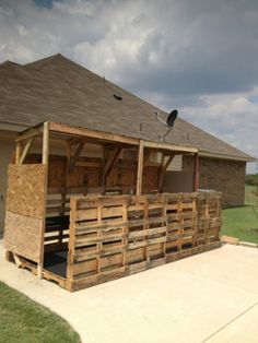 a wooden structure sitting in the middle of a yard