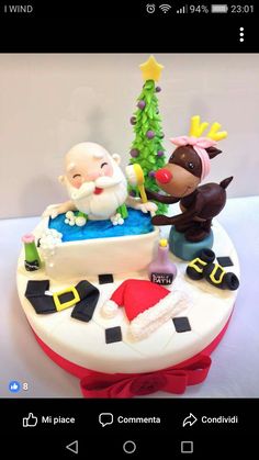 a cake decorated to look like santa and reindeer