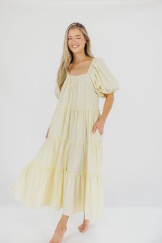 Gently feminine, the Eva Puffed Sleeve Maxi Dress is the perfect choice for the fashion-forward woman. Featuring dramatic balloon sleeves, an elastic neckline for easy wear (and easy nursing!), and tiers of ruffles for a charming yet sophisticated look, this elegant maxi dress is designed with style and comfort in mind. Its relaxed fit makes it a gorgeous choice for expecting mamas. FIT: Runs slightly oversized - very relaxed fit. Your true size will accommodate most baby bumps. MATERIAL: 91% Po Garment Details, Tiered Ruffle Skirt, Elegant Maxi Dress, Sleeve Maxi Dress, Baby Bumps, Low Iron, Maxi Dress With Sleeves, Ruffle Skirt, Pale Yellow