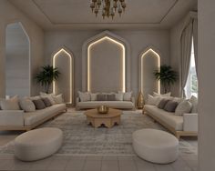 a living room filled with lots of white furniture