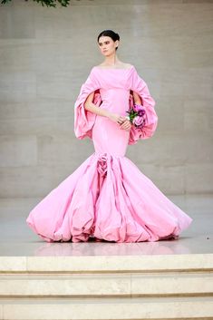 Off the shoulder exaggerated draped sleeve gown in Taffeta fabric with rosette embellishment