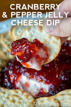 cranberry and pepper jelly cheese dip on crackers with text overlay that reads, cranberry and pepper jelly cheese dip