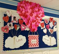 a bulletin board with hearts attached to it