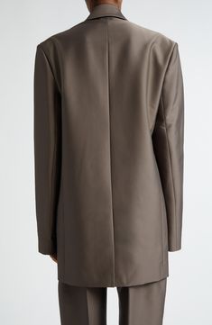 The label's focus on impeccable tailoring and minimalist beauty is evident in a double-breasted blazer cut from sleek satin in a boldly oversized silhouette. 34" length (size 36 FR) Double-breasted button closure Peaked lapels Front flap pockets Lined 71% polyester, 21% cotton, 8% bicomponent polyester Dry clean Imported Designer Clothing Satin Outerwear With Notch Lapel And Hidden Button Closure, Single Breasted Satin Outerwear For Business, Single-breasted Satin Outerwear For Business, Sleek Notch Lapel Blazer Dress, Notch Lapel Satin Outerwear For Fall, Fall Satin Outerwear With Notch Lapel, Fall Satin Notch Lapel Outerwear, Fall Satin Single Breasted Outerwear, Fall Satin Single-breasted Outerwear