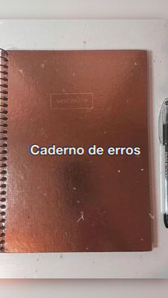 a notebook with the words cademo de eros written on it next to a pen