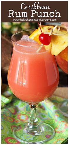 a drink in a glass with fruit on the side