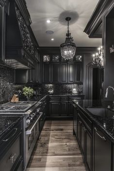 an elegant kitchen with black cabinets and marble counter tops, chandelier above the stove