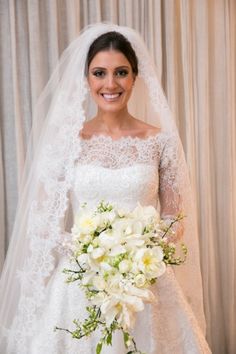 a woman in a wedding dress holding a bouquet