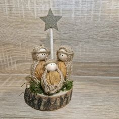 two little sheeps sitting on top of a tree stump with a star in the background