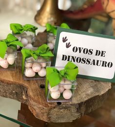 small glass vases filled with white and green candies on top of a wooden table