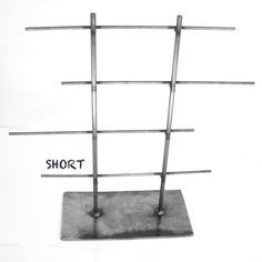 a black and white photo of a metal object with short words written on the side