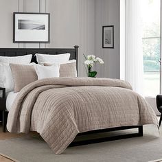 a bed in a bedroom with white and gray decor