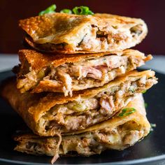 a stack of food sitting on top of a black plate