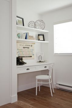 a white desk and chair in front of a book shelf with books on top of it