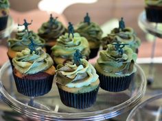 Camo cake batter baked in camo cupcake liners with camo buttercream icing topped with army men displayed at a Tour Number Four birthday party cake and food table Army Birthday Cupcakes, Army Theme Cupcakes, Army Bday Cake, Army Cupcakes Ideas, Army Men Cake, Army Themed Cake, Army Cupcakes, Camo Cakes, Army Birthday Cakes