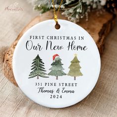 personalized christmas ornament with pine trees and santa's hat on it