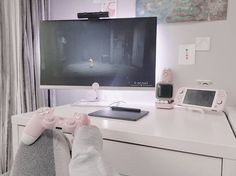 the person is playing video games on their computer monitor and feet are propped up in front of them