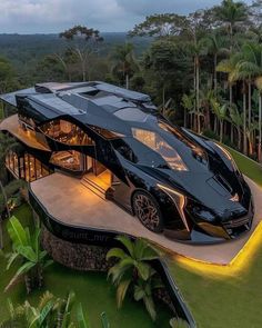 an aerial view of a futuristic house in the middle of palm trees and greenery