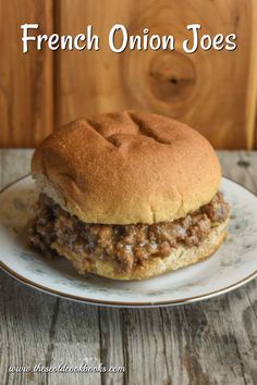 a sandwich on a plate with the words french onion joes in front of it