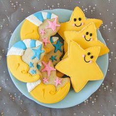 decorated cookies on a plate with stars and moon