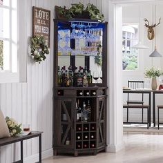 a bar with wine glasses and bottles on it in the corner of a living room