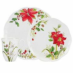 a christmas dinner set with poinsettis and holly on the plate, cup and saucer