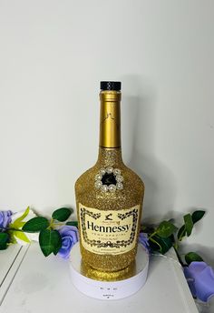 a bottle of hennesy with gold glitter on it