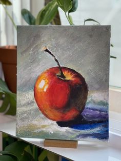 a painting of an apple sitting on top of a table next to a potted plant