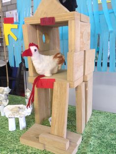 a wooden toy house with a chicken in it