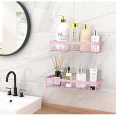 two pink shelves with soaps, lotions and other bathroom items in front of a white marble wall