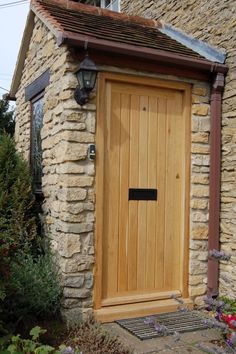 a wooden door on the side of a stone building