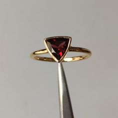 The Buyer Must Be Reads All Details About The Product . Material  14k Yellow Gold  . Gemstone  Natural Garnet  . Gemstone Colour .... Red . Gemstone Size  6x6mm . Gemstone Shape  Trillion . Birthstone  January  Birthstone Gold Ring Engagement, Dainty Wedding, Dainty Wedding Ring, January Birthstone, Garnet Ring, Colour Red, Garnet Rings, Garnet Gemstone, Yellow Gold Ring