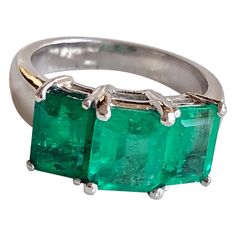 This is a beautiful and classic design Emerald Platinum Three Stone Engagement Ring Feature three genuine and natural COLOMBIAN emeralds, emerald cut weighing approx. 4.0 Carat. The emerald are prong set shimmering medium green, clarity VS. The ring weight 8.1 grams and is currently size 5.25 (sizable). Condition: Estate / Excellent. Antique Wedding Jewelry, Colombian Emerald Ring, Emerald Ring Engagement Diamond, Antique Diamond Rings, Contemporary Ring, Engagement Rings Opal, Classic Engagement Rings, Colombian Emeralds, Three Stone Engagement Rings