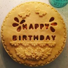 a birthday cake with the words happy birthday carved into it's pie crusts