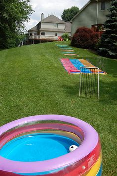 an inflatable pool is sitting on the lawn