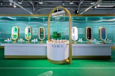 a store display with mirrors and sinks in the middle of green carpeted flooring