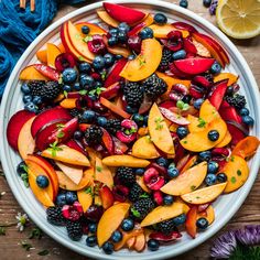 a white bowl filled with sliced fruit on top of a wooden table next to flowers