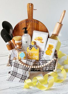 a basket filled with lots of items on top of a white wooden table next to yellow ribbons