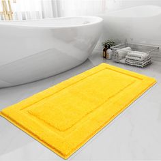 a bathroom with a bathtub and yellow rug