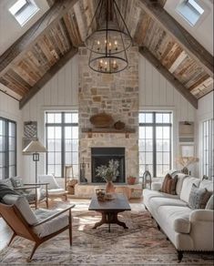 a living room filled with lots of furniture and a fire place in the middle of it