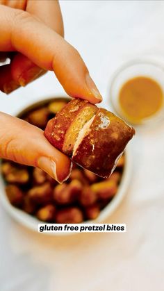 a person is dipping something into a bowl of beans with their fingers on the food