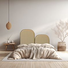 a bed sitting on top of a wooden floor next to a table with a vase