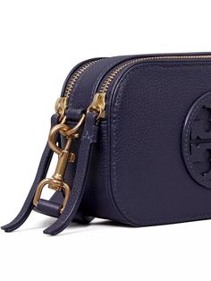 The Mini Miller pebbled leather crossbody bag packs style and functionality in a compact size. Featuring Tory Burch's recognizable monogram print and gold-tone logo hardware, this bag holds all your essentials for on-the-go Instagram snaps. Internal and exterior pockets keep your outfit organized while still leaving room to stash your phone. Luxury Travel Camera Bag With Branded Hardware, Luxury Crossbody Camera Bag With Branded Hardware, Luxury Branded Crossbody Camera Bag, Luxury Branded Hardware Crossbody Camera Bag, Luxury Leather Camera Bag With Branded Hardware, Luxury Tan Shoulder Bag With Zipper Closure, Pebbled Leather Crossbody Bag With Branded Hardware, Monogram Applique, Pebbled Leather Crossbody Bag