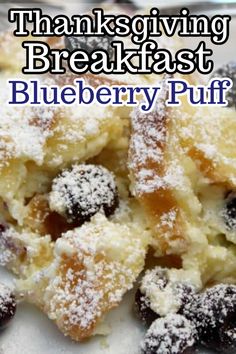 a white plate topped with blueberry puffs covered in powdered sugar and text that reads, thanksgiving breakfast blueberry puff