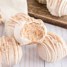 cinnamon rolls with frosting on a white table