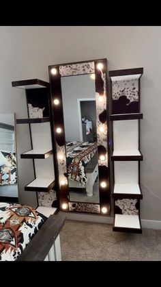 a mirror with lights on it in a bedroom