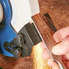 a person using a grinder to cut metal with a circular sawtoothing tool