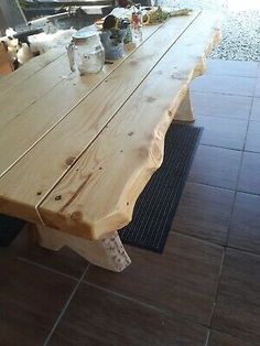 a wooden table sitting on top of a tiled floor