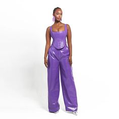 The rich purple hue adds a pop of color, creating a vibrant and eye-catching look that's perfect for those who love to stand out. The faux leather material provides a sleek and polished appearance.  The tailored fit ensures a flattering silhouette, hugging your curves in all the right places and providing both comfort and confidence. The versatile design allows you to effortlessly transition from day to night, making these pants a versatile choice for various occasions.  Why You’ll Love this Pant: Faux leather fabric, Fully lined, Elastic waist, inseam is 34 inches Dry Clean Only African Inspired Clothing, Rich Purple, Faux Leather Fabric, Blazer With Jeans, Faux Leather Pants, African Inspired, High Waisted Trousers, Independent Designers Fashion, Contemporary Fashion